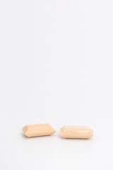 2 creamy color soaps in studio light on white background. one none wrap and another one is. Clipping Paths..