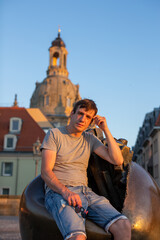 person sitting on a sculpture in the city