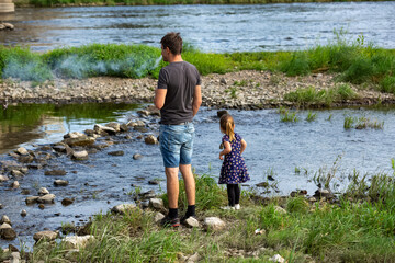 child and father on the river