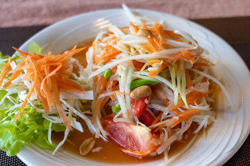 Papaya salad, Thai style salad with papaya fruits. Thailand cuisine photo close-up with selective focus