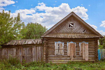 Abandoned traditional old wooden house. Summer view.