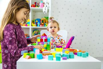 Fototapeta premium The child plays with toys in the room. Selective focus.