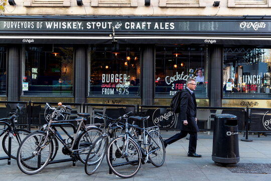A person walks past an O'Neill's pub in London