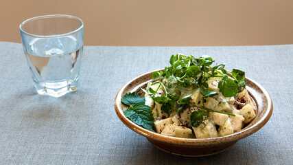 Kohlrabi salad with yoghurt and watercress and sumac spice in bowl. Mediterranean cuisine.