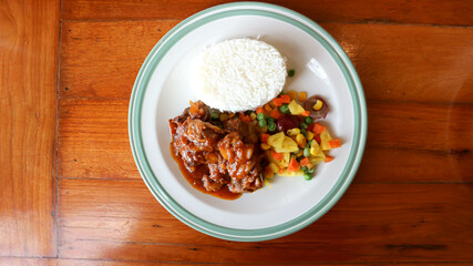 stewed pork ,pork with rice and sauce or rice topped with stew pork.