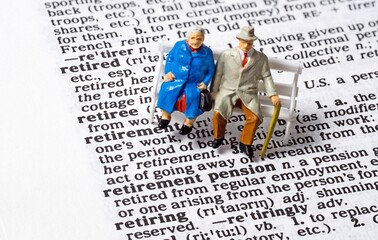 A conceptual image with miniature figures of an old aged elderly couple sitting next to the phrase...