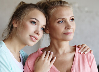 lifestyle, family and people concept: Happy young woman and her mother at home