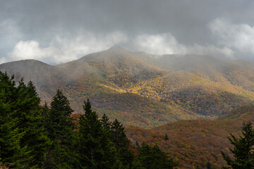 Fog Passes Low Over Fall Colored Mountains