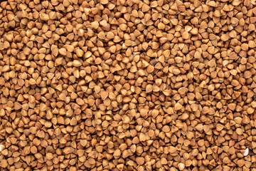 Uncooked organic buckwheat, macro, top view.