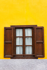 Yellow building with vintage windows.