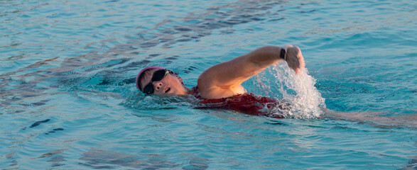 Women taking a breath while swimming in a pool