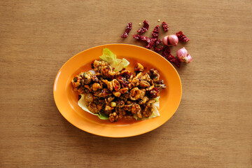 Deep Fried Baby Squid seafood with raw onion and chili on wood table background