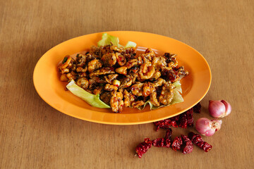Deep Fried Baby Squid seafood with raw onion and chili on wood table background
