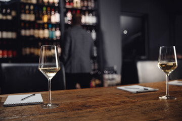 Concept experts tasting new sorts of white wine wooden table