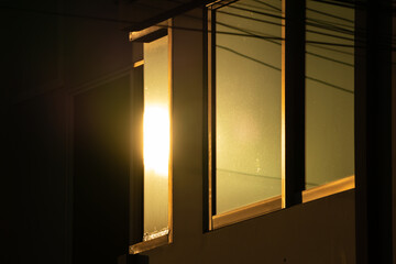 light in evening time shine to the window reflex on glass window