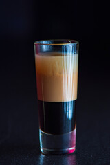 Tasty cocktail with alcohol in low key on a dark background.