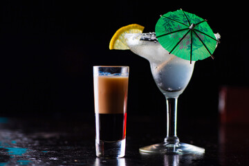 Tasty cocktail with alcohol in low key on a dark background.