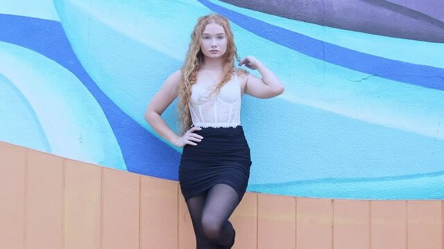 Redhead Gen Z girl in tights and black skirt portrait