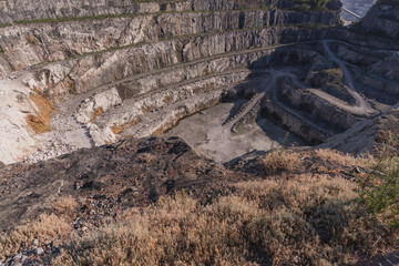 Dolomite quarry Photo from above. Industrial terraces in a quarry. Aerial view of open pit mining. Excavations of the Dolomite mine. Mining industry.
