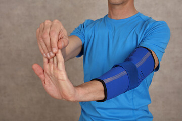 Man doing warming up exericeses : Elbow joint injury rehabilitation concept