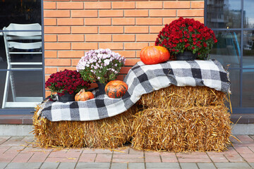 Pumpkins in hay and autumn flowers