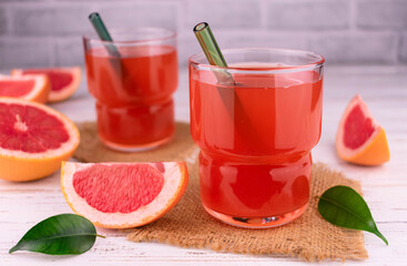 Two glasses with grapefruit juice. Close-up.