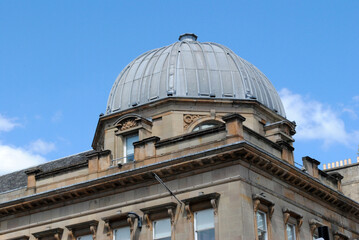 Fototapeta na wymiar Metal Dome on Corner of Old 19th Century Office Building seen against Blue Sky