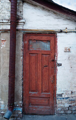 ruined and abandoned house exterior. Abandoned house. Broken glass in the window and falling plaster.