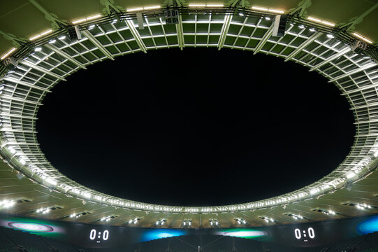 Night sky through the canopy of an outdoor football stadium. Zero-zero count.