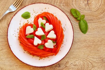 Valentine Italian Caprese salad with heart shaped tomatoes,heart shaped mozzarella cheeses,basil...