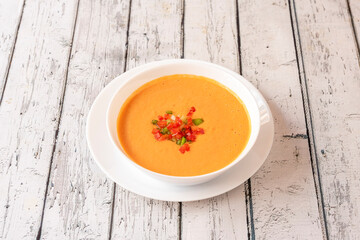 Gazpacho is a cold soup with various ingredients such as olive oil, vinegar, water, raw vegetables, usually tomatoes, cucumbers, peppers, onions, and garlic.