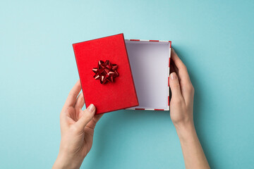 First person top view photo of valentine's day decorations woman's hands opening giftbox with red...