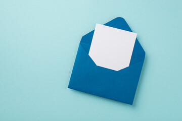 Top view photo of open blue envelope with paper sheet on isolated pastel blue background with empty space - obrazy, fototapety, plakaty