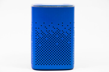 portable blue speaker on white background. The concept of listening to music. wireless audio...