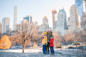 Family of mother and kids in Central Park during their vacation in New York City