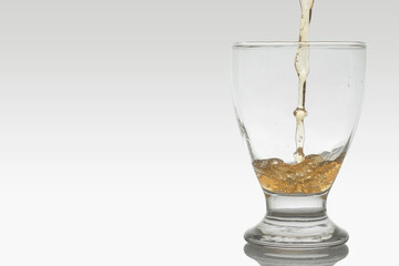 Pouring beer into a crystal glass, movement of beer into the glass, with copy space