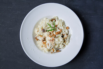 Tasty creamy risotto with mushrooms and almonds, top view. Traditional italian cuisine. 