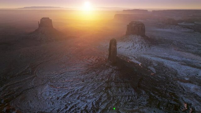 Beautiful sunrise over wild red rocks mountains in winter morning in Monument Valley, Utah Arizona, southwest USA. Wilderness nature aerial drone footage 4K with copy space background