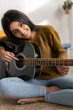 woman playing guitar indian teacher