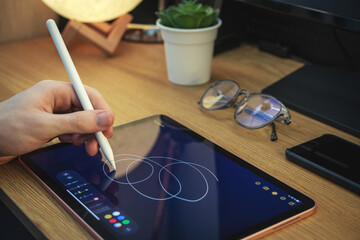Man using digital tablet for drawing. - 480245477