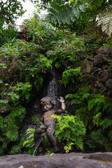 Nice fountain, of a boy sitting on a stream of water under a waterfall, in Funchal, Portugal.