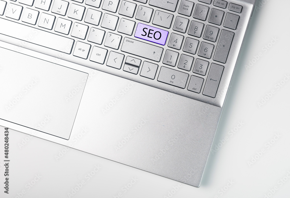 Poster seo word on laptop keyboard. button key with search engine optimization text.