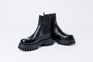 Women's black boots with genuine leather on a rough sole without laces. New collection of women's spring shoes