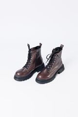 Graceful women's leather demi-season ankle boots with low heels. Studio photo for the catalog of the new collection of women's shoes 2022