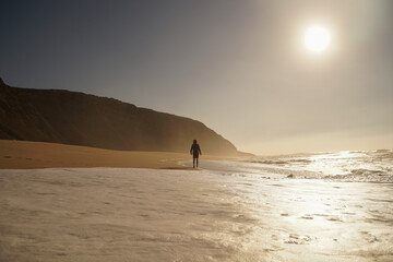 Fototapeta na wymiar Young man enjoying the empty beach