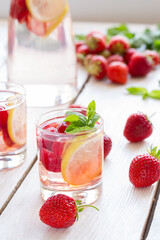 fresh lemonade with strawberries , lemon and mint