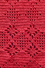 Crochted pink floral pattern. Knitted background.