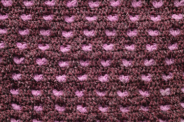 Violet and pink crocheted geometric pattern. Knitted texture.