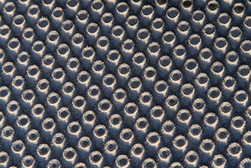 perforated metal sheet with frozen ice crystals 