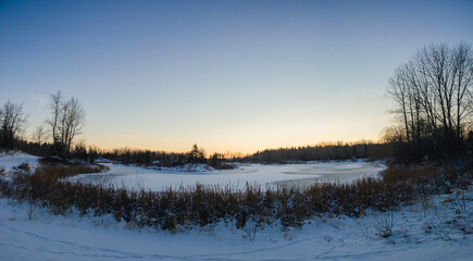 sunset panorama  over a frozen pond